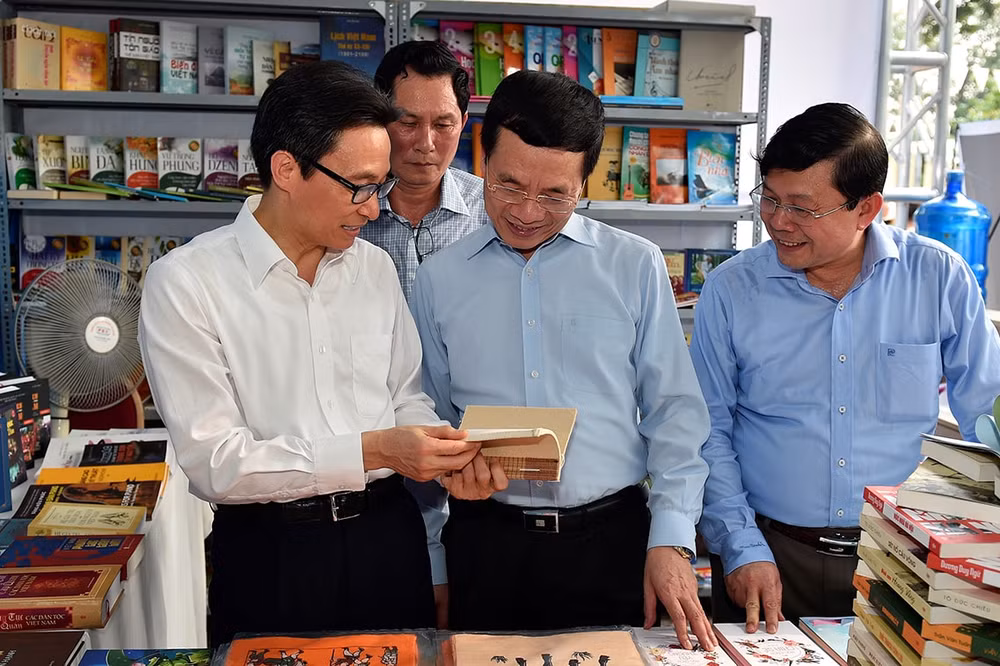 Phó Thủ tướng Vũ Đức Đam cùng Bộ trưởng Nguyễn Mạnh Hùng tham quan các gian sách. Ảnh VGP