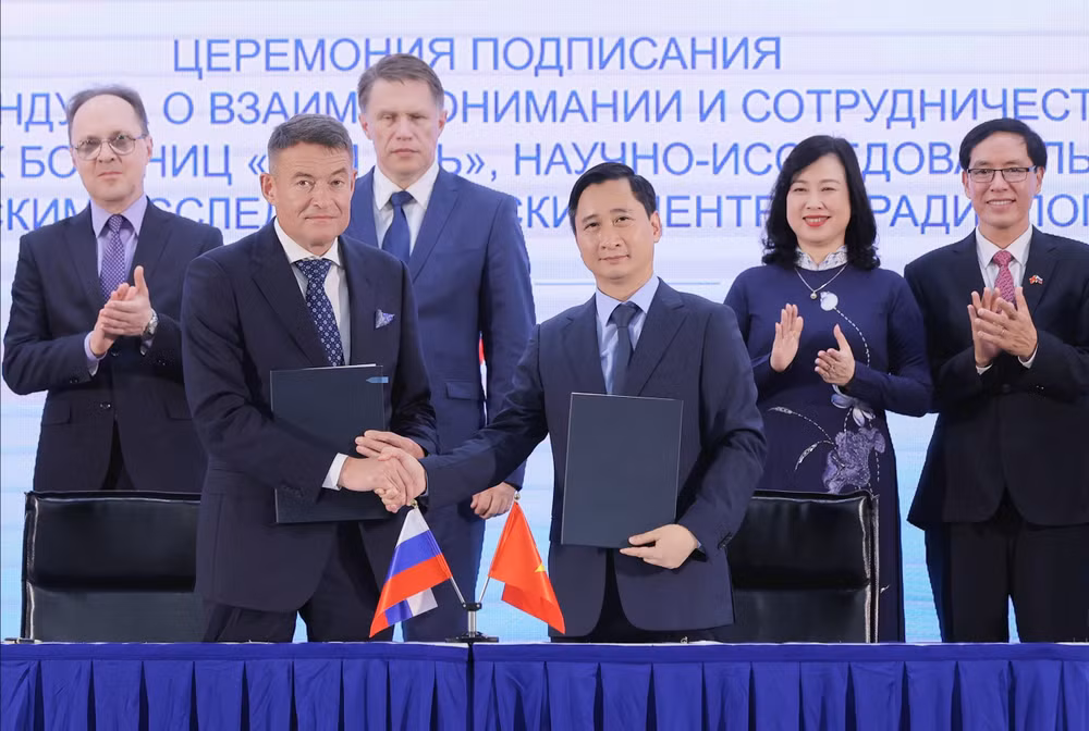 Ông Andrey Kaprin - Tổng giám đốc Trung tâm Y học Quốc gia về Xạ trị - Viện Hertsen Liên bang Nga trao đổi văn kiện hợp tác với ông Ngô Chí Dũng, Chủ tịch HĐQT Hệ thống B…