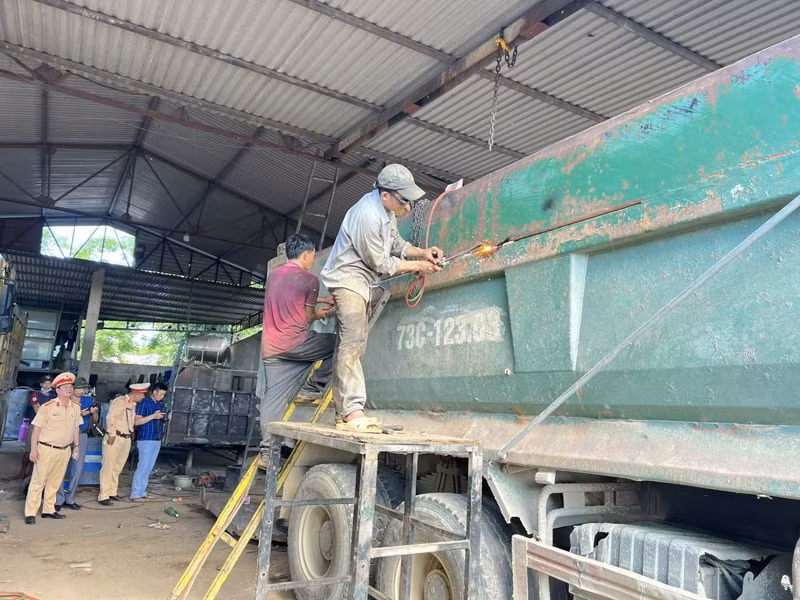 Phòng CSGT Quảng Bình giám sát việc cắt bỏ phần thành thùng xe có vi phạm.