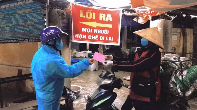 Người dân đi chợ phải có phiếu (ảnh TL).