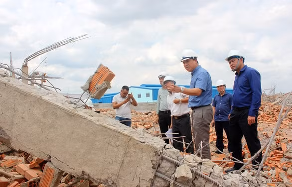 Cơ quan chức năng tìm nguyên nhân tường công trình sập làm 10 người chết. Ảnh: PV