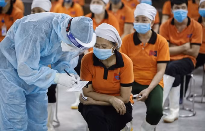 Kiểm tra, lấy mẫu xét nghiệm tiêm văc xin cho công nhân. Ảnh: Dân trí.