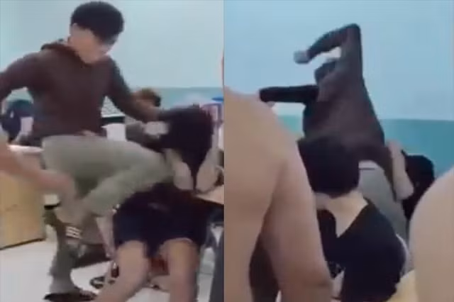 Hình ảnh nam thanh niên mặc đồng phục của lực lượng dân phòng lên gối, xuống chỏ vào người hai thiếu niên. Ảnh: Cắt từ clip