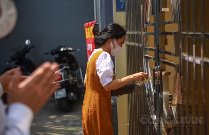 Tiền lẻ được người dân để vào bàn đã kê sẵn phía bên trong cửa của Phủ Tây Hồ.