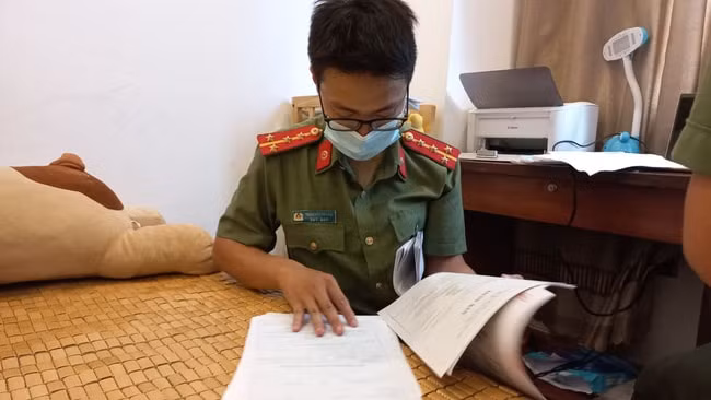 Lực lượng chức năng tiến hành khám xét, thu giữ các tài liệu liên quan tại nơi ở của Lộc. Ảnh: CACC