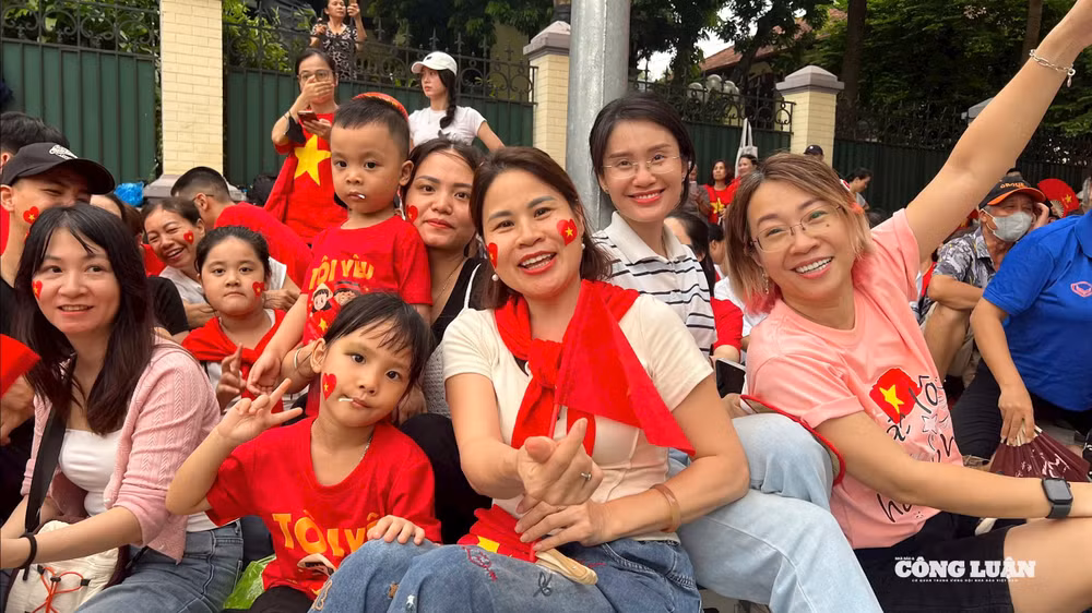 Chị Lê Thị Thủy ở phố Mai Dịch, Hà Nội (ngồi hàng đầu, cầm cờ) đi cùng người thân từ rất sớm để xem tổng hợp luyện diễu binh, diễu hành A80. Ảnh: Thiên An.
