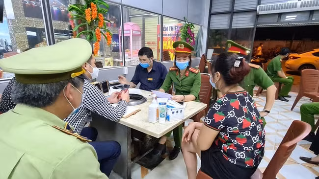 Bà Hiền (áo hoa đỏ) chứng kiến tổ công tác kiểm tra. Ảnh: TL.