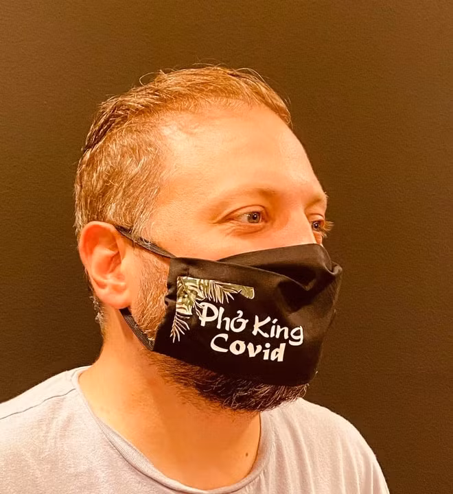 Chủ quán đeo khẩu trang in dòng chữ Phở King Covid. Ảnh: Restaurant Pho King Bon.
