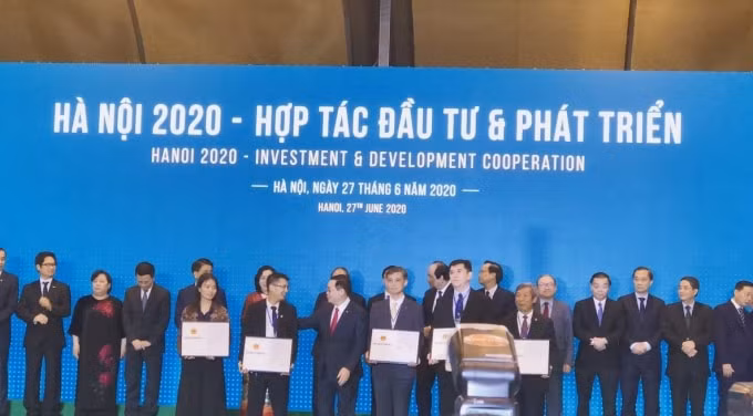PCT Tổng công ty CP Thương mại Xây dựng nhận quyết định chủ trương đầu tư từ Bí thư Thành ủy Hà Nội Vương Đình Huệ. Ảnh: Hoàng Lâm.