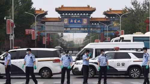 Cảnh sát canh gác ngoài cổng chợ Tân Phát Địa ngày 13/6. Ảnh: AFP