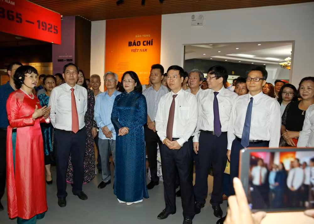 Các đồng chí lãnh đạo Đảng và Nhà nước, lãnh đạo Hội Nhà báo Việt Nam nghe giới thiệu về các giai đoạn của lịch sử báo chí Việt Nam. Ảnh: Sơn Hải