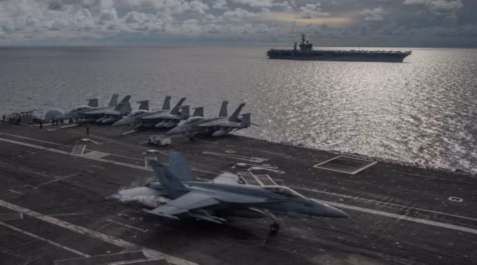 Một máy bay chiến đấu hạ cánh trên sàn đáp tàu sân bay USS Ronald Reagan khi tàu sân bay USS Nimitz khởi hành gần đó, trong cuộc tập trận ở Biển Đông, ngày 6 tháng 7 năm 2020 - Ảnh: Hải quân Hoa Kỳ