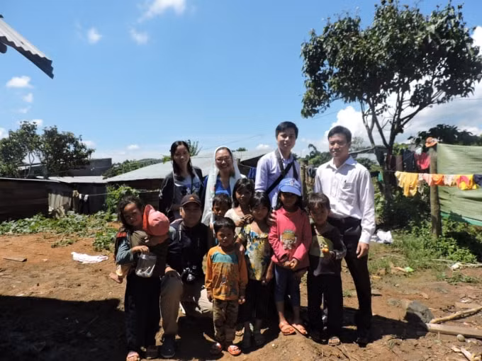 Nhà báo Chu Minh Khôi cùng các đồng nghiệp chụp ảnh với những đứa trẻ nghèo ở Lâm Đồng.