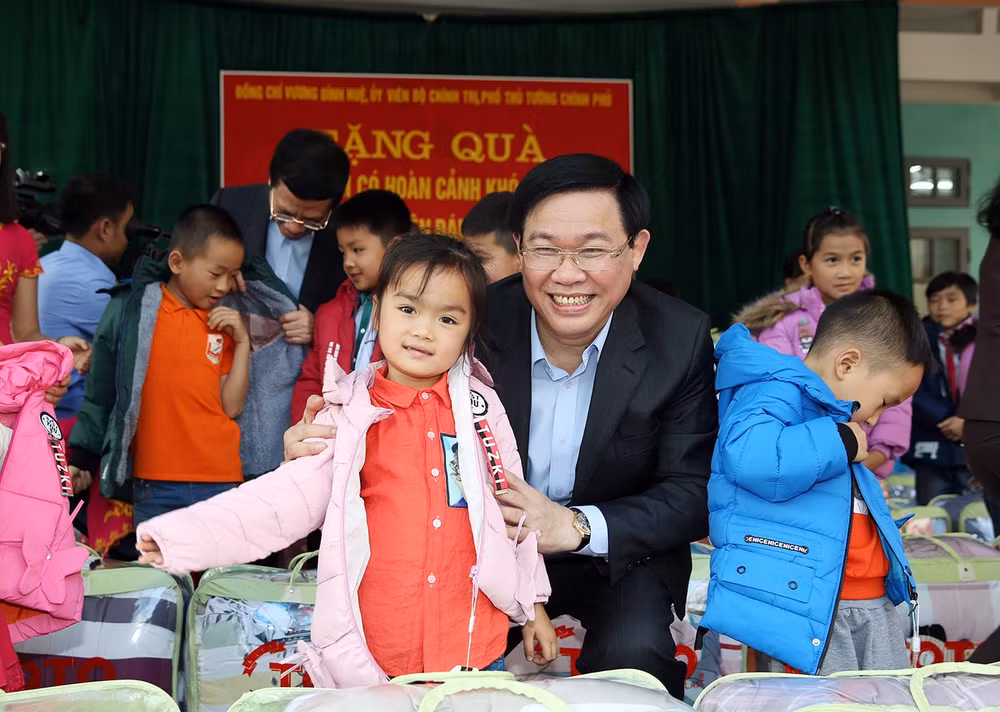 Phó Thủ tướng Vương Đình Huệ trao áo ấm cho trẻ em Thung Nai. Ảnh: VGP