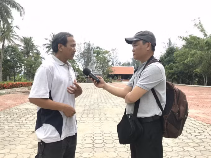 Nhà báo Tấn An phỏng vấn nhân vật trong tác phẩm “Thông điệp hòa bình ở Mỹ Lai”. (Ảnh: NVCC)