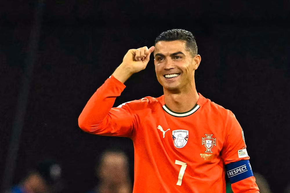 Portugal's forward #07 Cristiano Ronaldo (R) celebrates after scoring the 1-2 penalty goal as Hungary's midfielder #17 Callum Styles reacts during the 2026 World Cup qualifiers Europe zone group F football match between Hungary and Portugal on September 9, 2025 in Budapest, Hungary. (Photo by Attila KISBENEDEK / AFP) (Photo by ATTILA KISBENEDEK/AFP via Getty Images) 