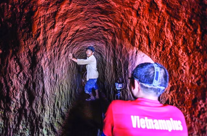 Phóng viên báo điện tử Vietnamplus Sơn Bách chui xuống giếng cạn ở Tây Nguyên để tác nghiệp (Ảnh: Lê Minh Sơn)