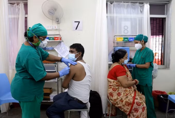 Rohit Gupta, 27 tuổi và Nandani Gupta, 42 tuổi, nhận được liều đầu tiên của họ vắc xin COVISHIELD, do Viện Huyết thanh của Ấn Độ sản xuất, tại một trung tâm tiêm chủng ở Mumbai, Ấn Độ, ngày 3 tháng 5 năm 2021 - Ảnh: REUTERS / Niharika Kulkarni