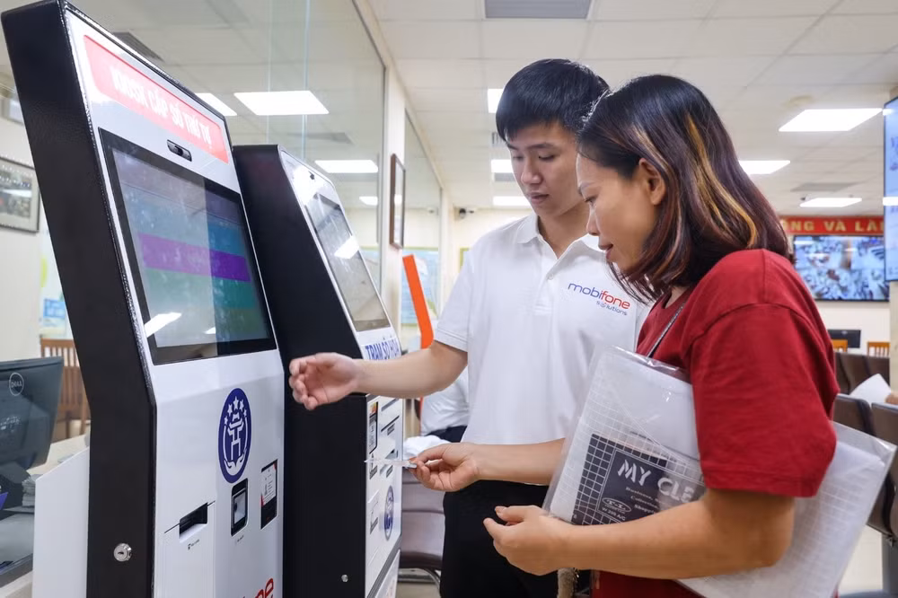 Cán bộ kỹ thuật MobiFone hướng dẫn người dân thực hiện thao tác trên hệ thống thông tin giải quyết thủ tục hành chính theo mô hình chính quyền địa phương 2 cấp