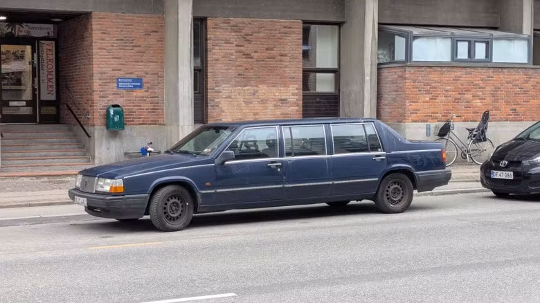 A blue Volvo limo parked on a European street