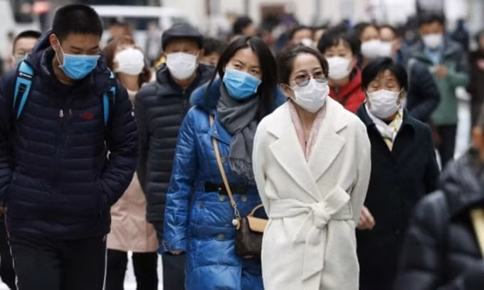 Người dân Nhật Bản đeo khẩu trang phòng chống nCoV trên đường phố Tokyo hôm 22/1. Ảnh: Kyodo News.