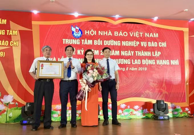 Đồng chí Thuận Hữu, Ủy viên Trung ương Đảng, Tổng Biên tập Báo Nhân dân, Phó trưởng Ban Tuyên giáo Trung ương, Chủ tịch Hội Nhà báo Việt Nam trao Huân chương Lao động Hạng Nhì cho Trung tâm Bồi dưỡng nghiệp vụ báo chí. Ảnh: Hoàng Huy