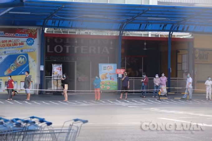 Để tránh tập trung đông người, MM Mega Market An Phú lập rào chắn, mỗi lần chỉ vài chục khách được vào mua